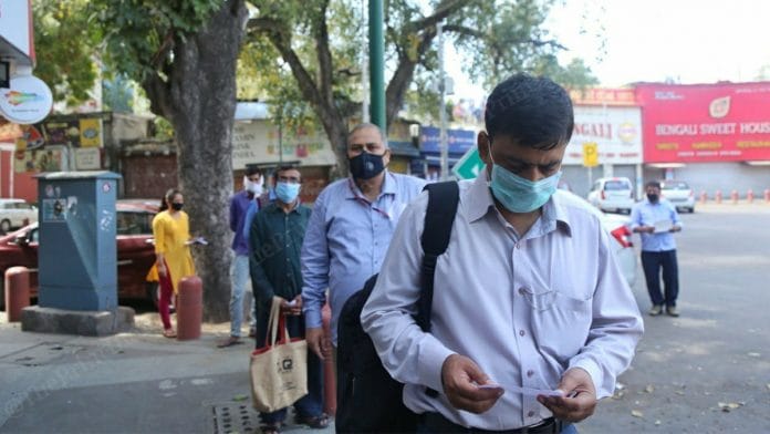 People line up outside a grocery store to buy supplies Wednesday | Photo: Manisha Mondal | ThePrint
