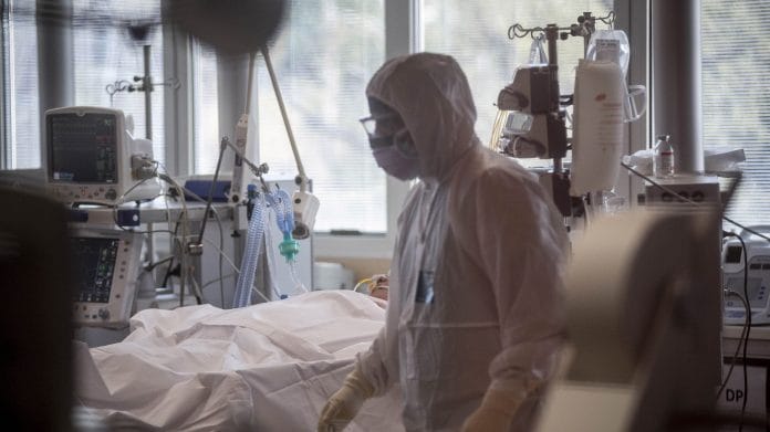 A doctor works in a coronavirus isolation wing in a hospital in Rome, Italy. | Bloomberg