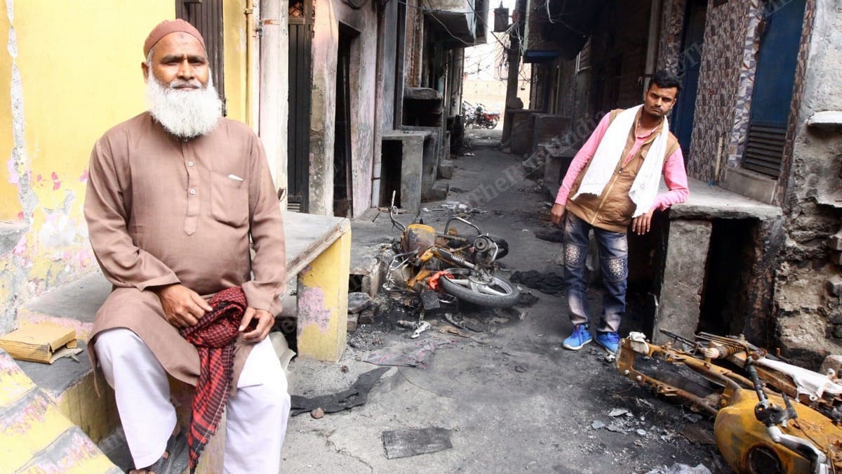 Mohammed Hasmuddin (Left) and Mohammed Sharafat outside their vandalised and looted home. | Photo: Praveen Jain | ThePrint