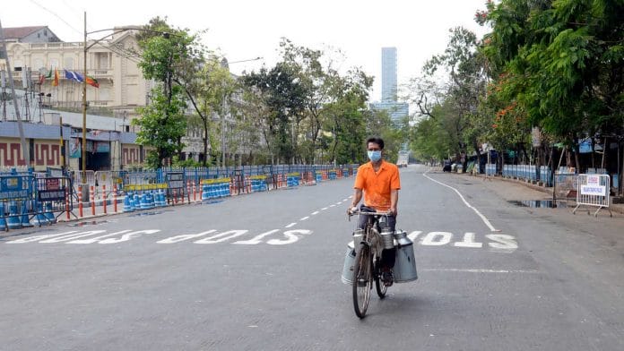 A milkman rides a bicycle on the deserted streets of Kolkata Sunday as India observes 'janata curfew' to prevent the spread of COVID-19 | Photo: ANI