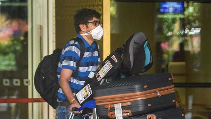 A passenger wearing masks at the Mumbai airport