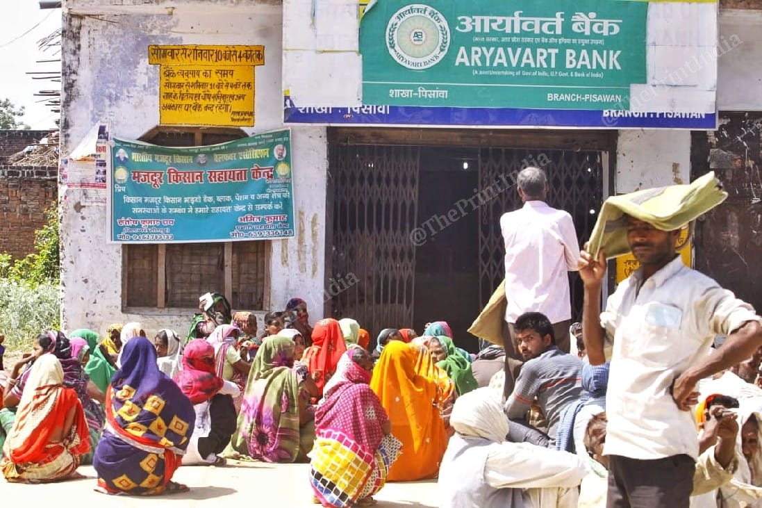 Piswan residents often sit down outside the bank when the wait lasts too long