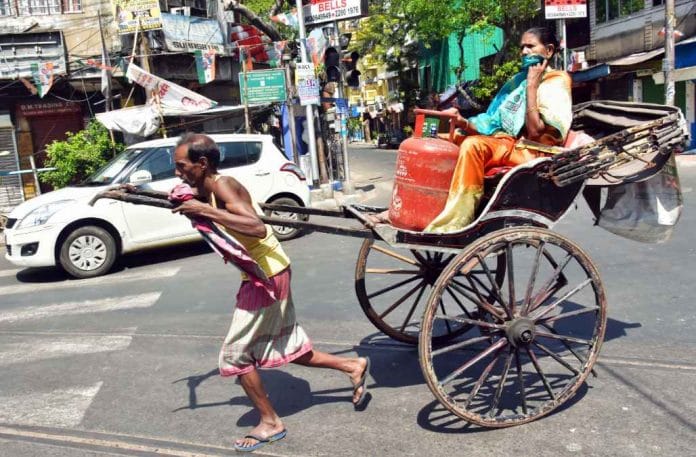 An elderly Kolkata woman and a rickshaw puller seen on a deserted Kolkata street amid the shutdown | Representational image | ANI