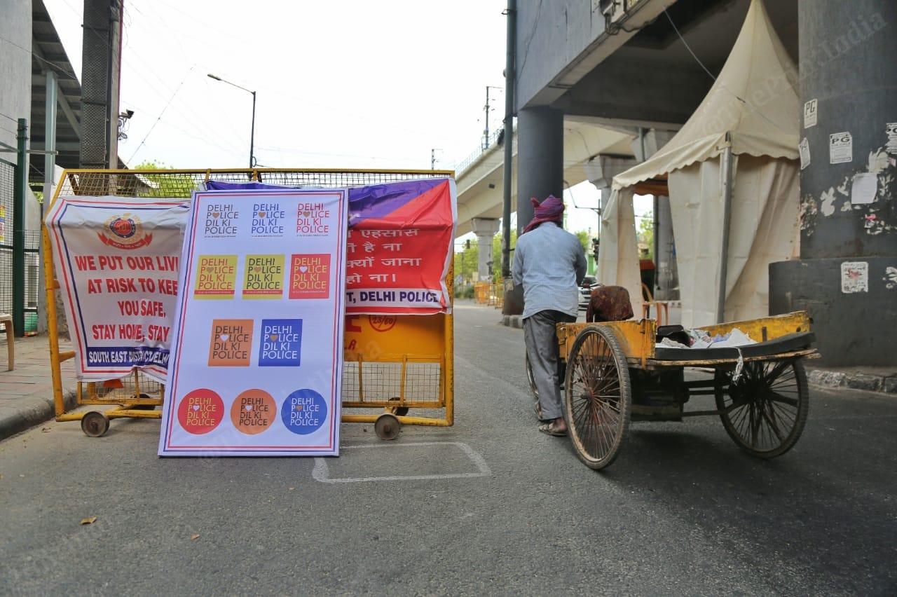 A Delhi Police banner, with its new Twitter handle name, at a barricade in Tughlaqabad Extension. Photo: Manisha Mondal | ThePrint