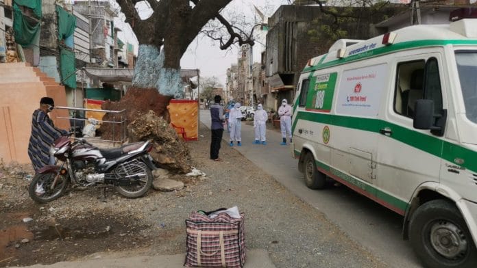 A Covid-19 patient waiting to be picked up by the ambulance in Tatpatti Bhakal