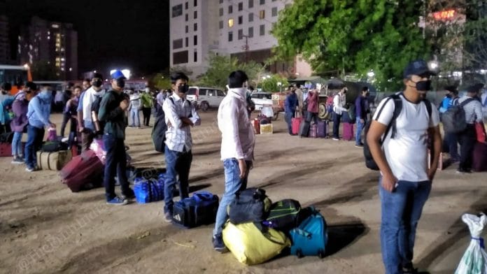 Students queue up to take the buses sent by the UP govt to get them home | Photo: Praveen Jain | ThePrint