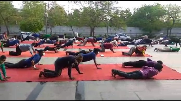 Migrant workers during a PT session at Yamuna Sports Complex in New Delhi