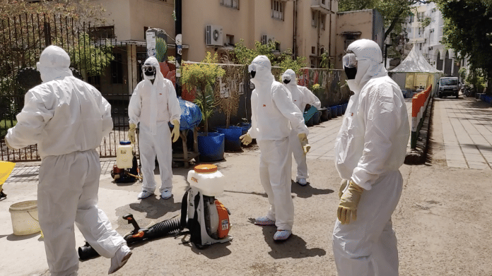 SDMC workers spray disinfectant at Tablighi Jamaat headquarters and the surrounding area | Photo: Bismee Taskin | ThePrint