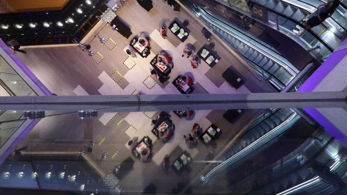 People queue to get a free refill of hand sanitiser with a safety distancing markers in place at a shopping mall on April 2, 2020 in Singapore.| Photographer: Suhaimi Abdullah | Getty Images AsiaPac | Bloomberg