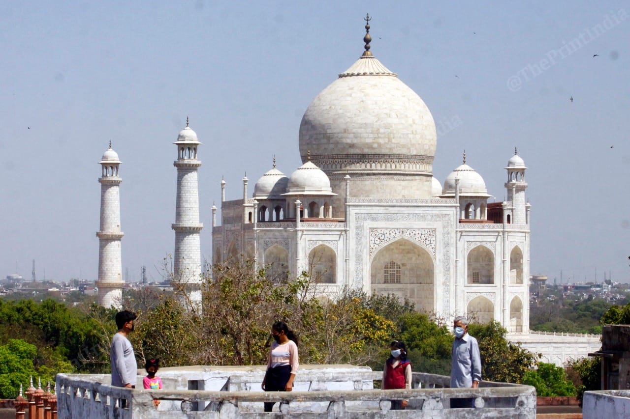 People wearing masks stand on the roof | Photo: Praveen Jain | ThePrint