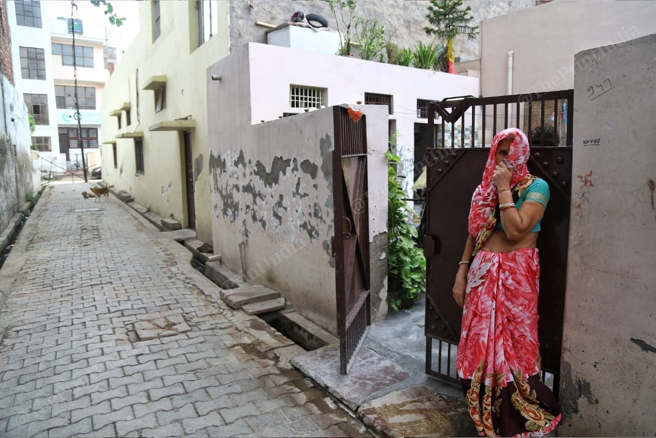 A woman stands on a deserted street in Agra | Suraj Singh Bisht | ThePrint