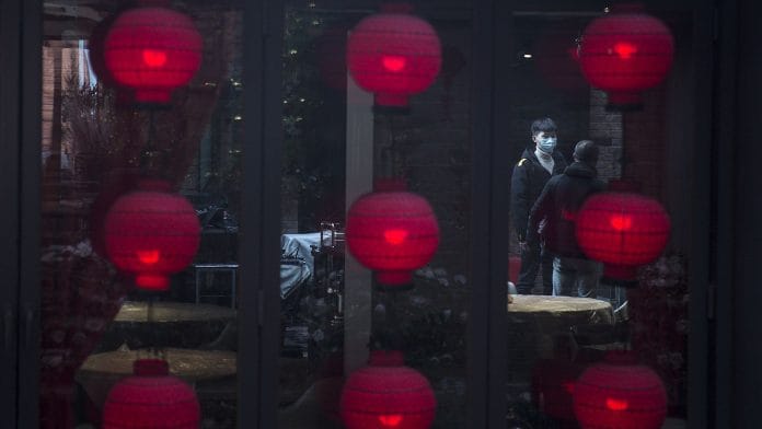 A waiter is standing outside the restaurant in a shopping district on April 01, 2020 in Wuhan, Hubei, China.(Representational Image) | Photo by Getty Images | Bloomberg