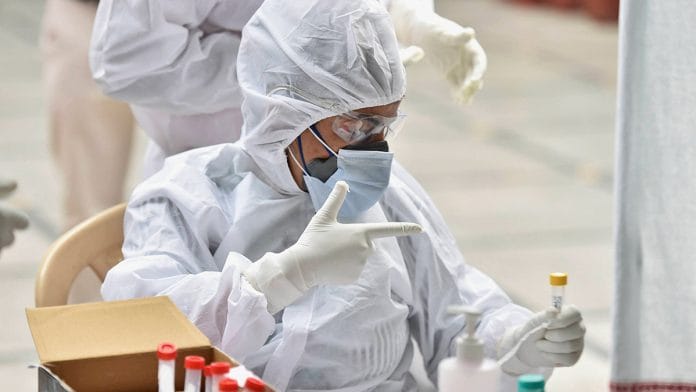 Health workers collect swab samples for Covid-19 tests in New Delhi | PTI