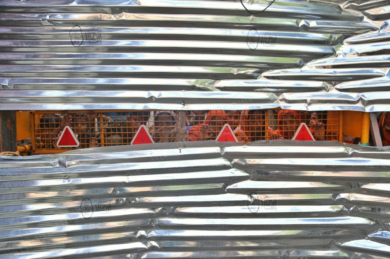 Residents in sealed lanes adjacent to Ajiman Bibi's family home peeking from the barricades. | Photo: Manisha Mondal/ThePrint