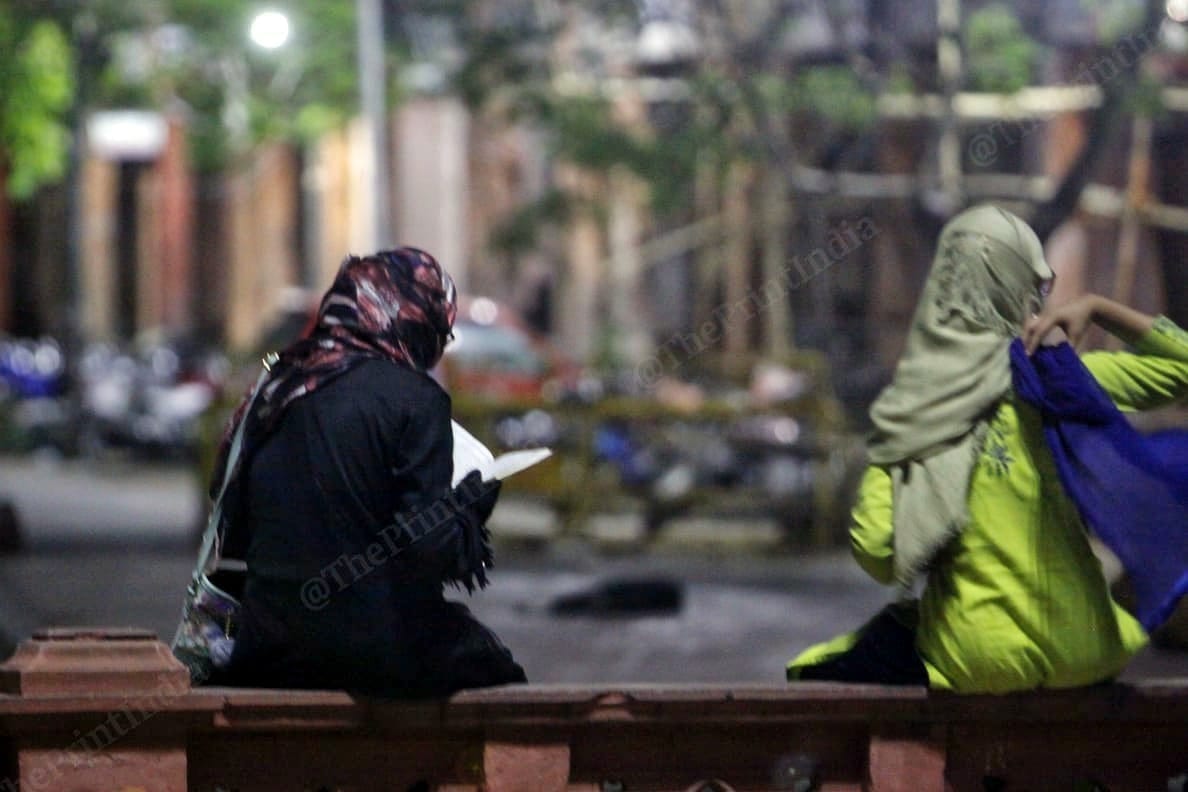 A woman reads the Quran before being ushered into an ambulance in Jaipur. | Photo: Praveen Jain/ThePrint