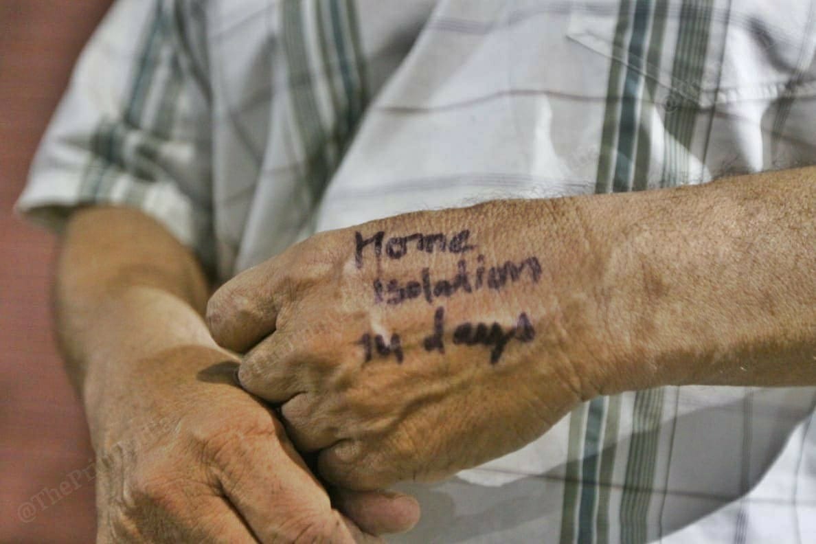 A cousin of the 45-year-old man who returned from Oman displays a quarantine stamp. | Photo: Praveen Jain/ThePrint