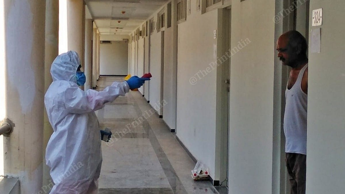 A health worker screens the patient quarantined next door at the High Speed Rail Training Institute in Vadodara | Photo: Praveen Jain | ThePrint