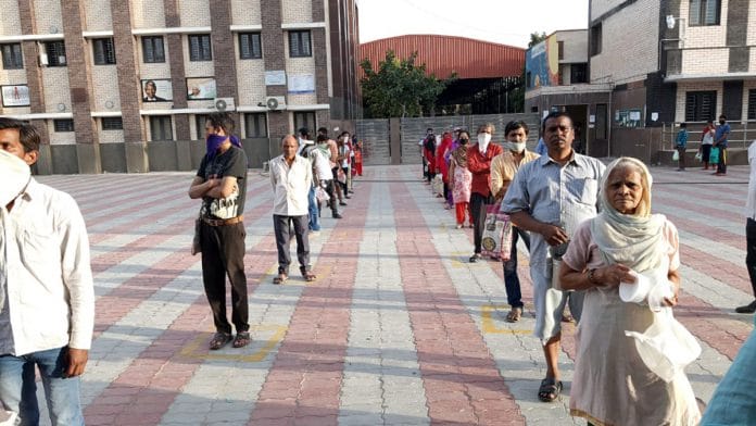 People maintaining distance while standing in a queue | ANI