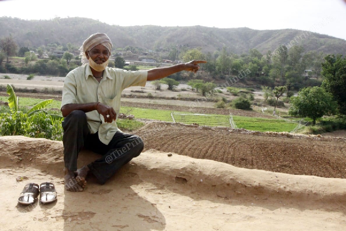 Ratanpur resident Narsingh Dama points towards the neighbouring village in Gujarat | Praveen Jain | ThePrint