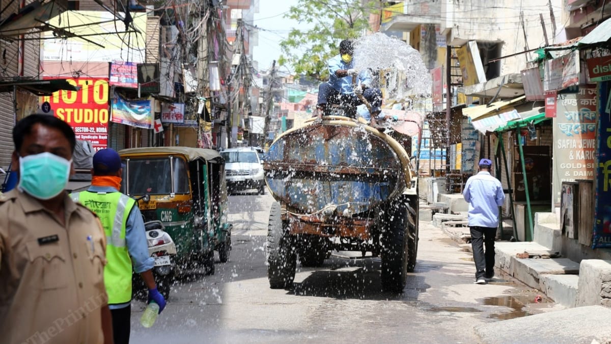 A water tanker sanitising the SHO’s vehicle in Sector 22, Noida