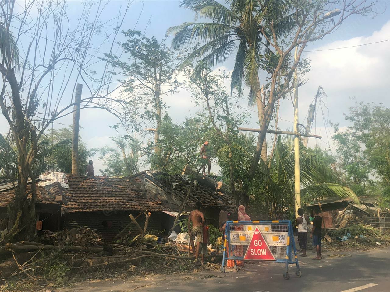 Villagers working on their own to remove uprooted trees | Photo: Madhuparna Das | ThePrint