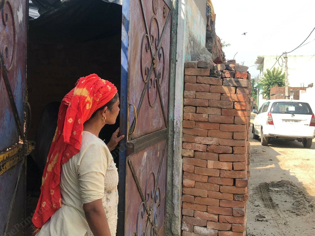 Nanhi, a milk seller of Mansurpur village located near the Rampur-Bareilly Highway. She is looking out of her house. The economy of Mansurpur village runs on animal husbandry| Photo: Jyoti Yadav | ThePrint