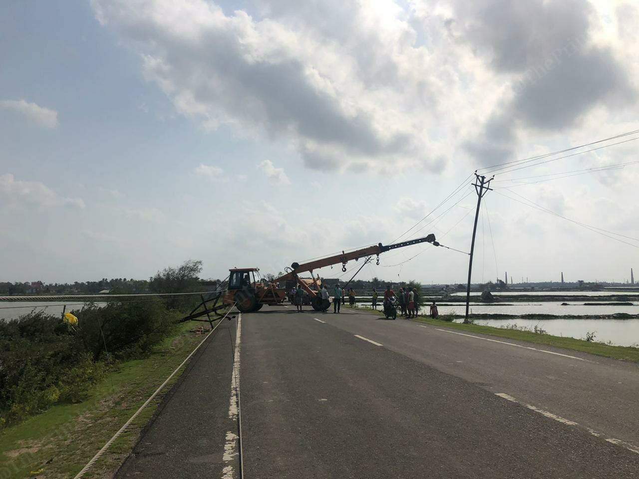 Local agencies trying to remove uprooted electric posts from road | Photo: Madhuparna Das | ThePrint
