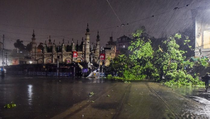 A tree uprooted during heavy rain infront Tipu Sultan Masjid after the landfall of super cyclone 'Amphan', in Kolkata | PTI