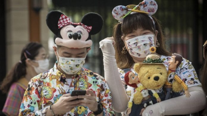 Visitors wearing Disney-themed protective masks during the reopening of the Walt Disney Co. Shanghai Disneyland theme park | Bloomberg