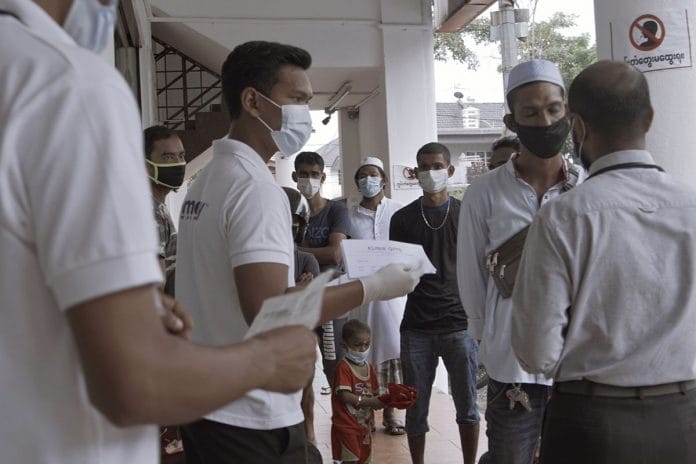 A group of Rohingya refugees wait for their turn to be screened at a local clinic facility on March 24, 2020 in Kuala Lumpur, Malaysia. (Photo by Rahman Roslan/Getty Images via Bloomberg)