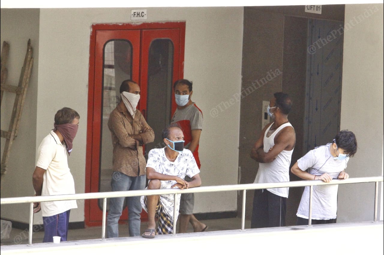 People at the quarantine centre look outside their balconies | Photo: Praveen Jain | ThePrint