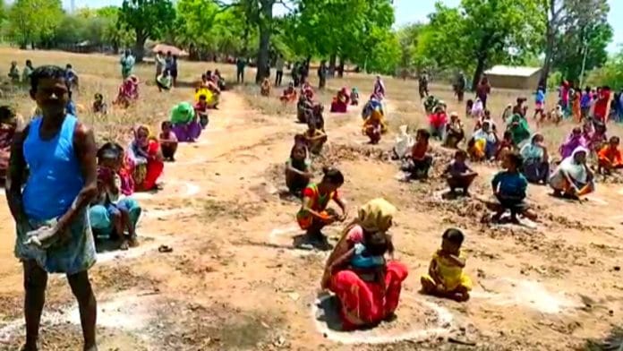 Villagers sitting by maintaining the social distance as they attend a program organised by the CRPF to make people aware of Covid-19, in Sukma on 29 April 2020