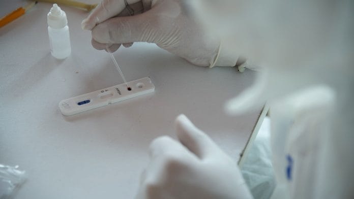 A medical worker puts a drop of blood into a rapid blood test (Representational image) | Carlos Becerra | Bloomberg File photo
