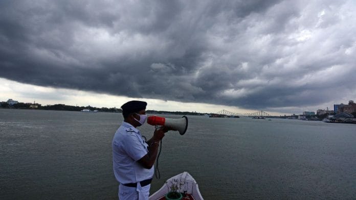 A Kolkata policeman makes a security announcement as dark clouds gather over the city Tuesday, a day before Amphan is supposed to make landfall | ANI