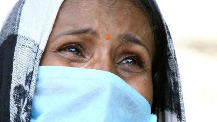 A woman who could not afford the ticket cries outside the station | Photo: Suraj Singh Bisht | ThePrint