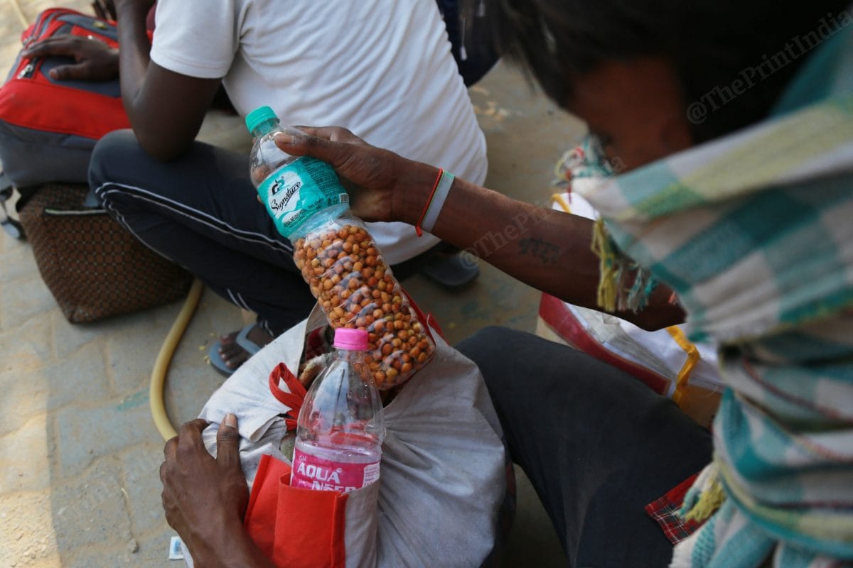 A worker submerged chana in water so that when it plummet they can eat it during their journey | Photo: Manisha Mondal | ThePrint