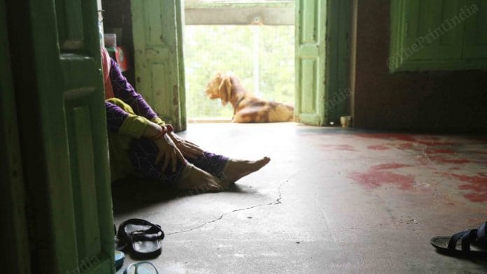 After bringing ration to the third floor, a woman rests | Photo: Manisha Mondal | ThePrint