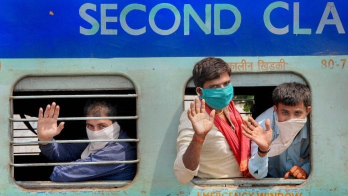 File photo | Migrant labourers wave from a train as they leave for Barauni in UP, during the nationwide lockdown, in Amritsar, 10 May | PTI