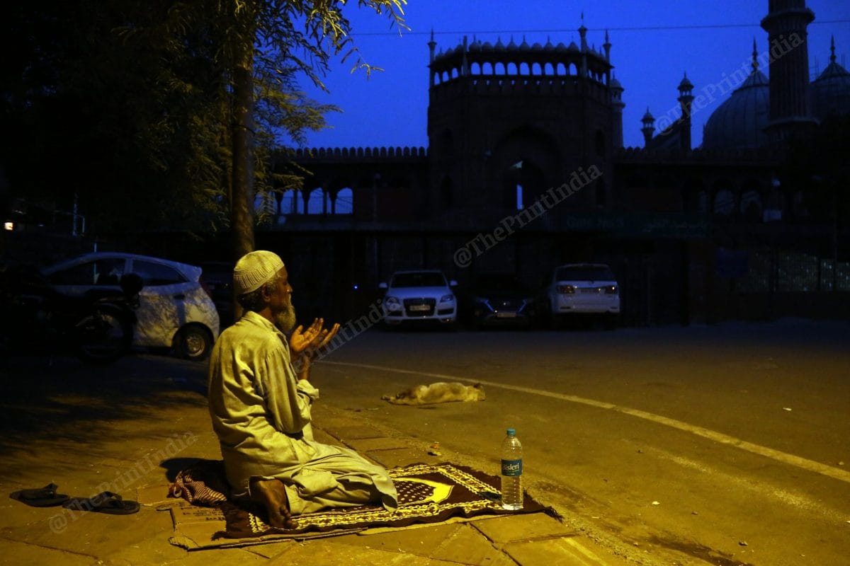 A man offers namaz on the empty roads near Jama Masjid | Photo: Suraj Singh Bisht | ThePrint