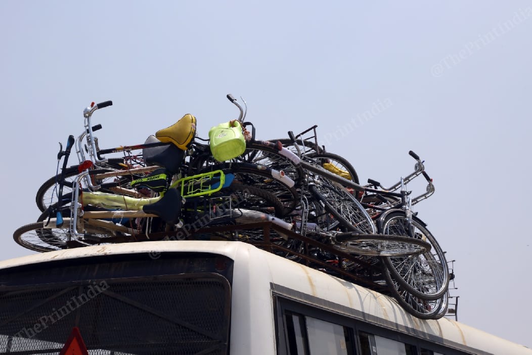 A testimony to their long journey - bicycles stacked atop a bus at the UP-Bihar border | Suraj Singh Bisht | ThePrint