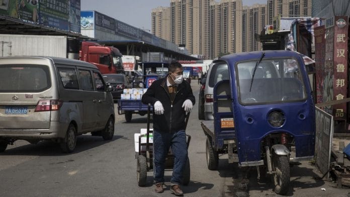 A vendor walks with a cart of goods at the Baishazhou wet market in Wuhan | Representational image | Bloomberg