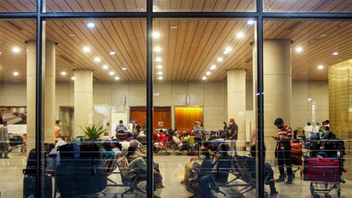 Indian nationals who were stranded in Singapore wait to board buses for a quarantine centre at Mumbai International Airport after being evacuated | PTI