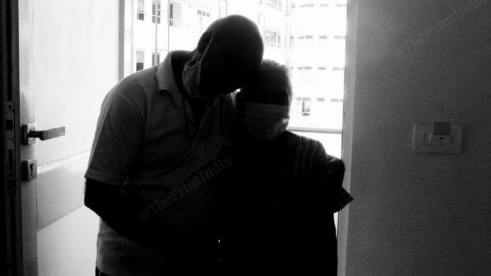 Sanjay Kumar Parekh holds his mother Shardaben at a quarantine facility in Vadodara | Photo: Praveen Jain | ThePrint