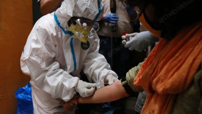 A health worker draws a blood sample as part of the serological survey in Delhi | Photo: Manisha Mondal | ThePrint