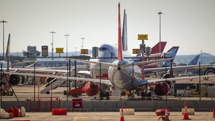 Passenger aircraft stand grounded on the tarmac at Manchester Airport, operated by Manchester Airport Plc, in Manchester, U.K. | Photographer: Anthony Devlin | Bloomberg