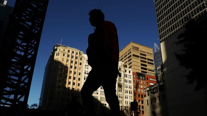 A pedestrian walks through Martin Place in Sydney, Australia. | Photographer: Brendon Thorne | Bloomberg
