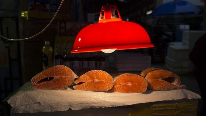 A light illuminates salmon for sale at a store (Representational Image) | Photographer:Brent Lewin | Bloomberg
