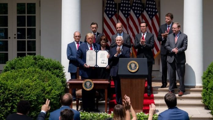 US President Donald Trump signing the Paycheck Protection Program Flexibility Act with other officials | Twitter