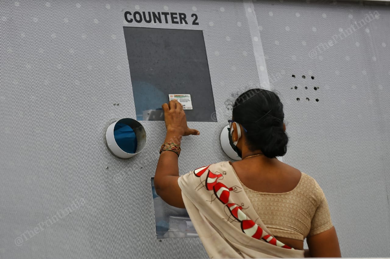A woman shows her identity card for the details | Photo: Suraj Singh Bisht | ThePrint