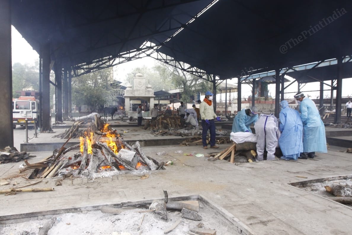 Hospital workers help with the cremation of a Covid patient | Praveen Jain | ThePrint